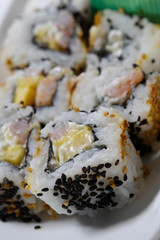 Sushi is traditionally made with medium-grain white rice. It is very often prepared with seafood, such as squid, eel, yellowtail, salmon, tuna or imitation crab meat.
