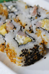 Sushi is traditionally made with medium-grain white rice. It is very often prepared with seafood, such as squid, eel, yellowtail, salmon, tuna or imitation crab meat.
