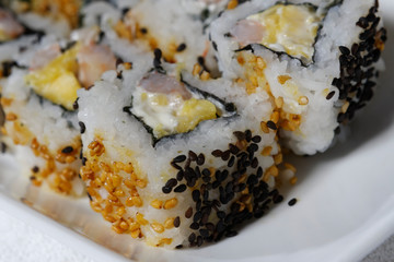Sushi is traditionally made with medium-grain white rice. It is very often prepared with seafood, such as squid, eel, yellowtail, salmon, tuna or imitation crab meat.