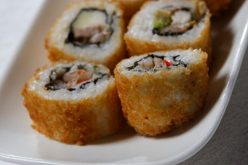 Sushi is traditionally made with medium-grain white rice. It is very often prepared with seafood, such as squid, eel, yellowtail, salmon, tuna or imitation crab meat.