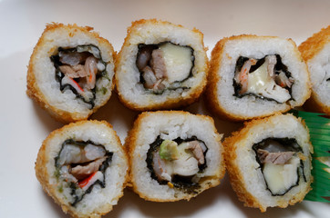 Sushi is traditionally made with medium-grain white rice. It is very often prepared with seafood, such as squid, eel, yellowtail, salmon, tuna or imitation crab meat.