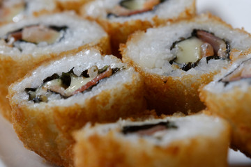 Sushi is traditionally made with medium-grain white rice. It is very often prepared with seafood, such as squid, eel, yellowtail, salmon, tuna or imitation crab meat.