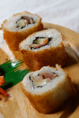 Sushi is traditionally made with medium-grain white rice. It is very often prepared with seafood, such as squid, eel, yellowtail, salmon, tuna or imitation crab meat.