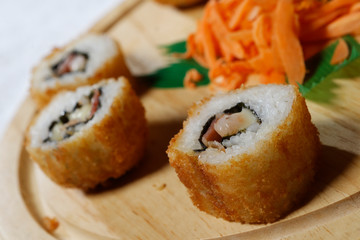 Sushi is traditionally made with medium-grain white rice. It is very often prepared with seafood, such as squid, eel, yellowtail, salmon, tuna or imitation crab meat.