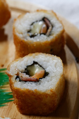 Sushi is traditionally made with medium-grain white rice. It is very often prepared with seafood, such as squid, eel, yellowtail, salmon, tuna or imitation crab meat.