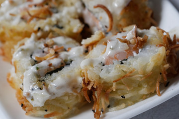 Sushi is traditionally made with medium-grain white rice. It is very often prepared with seafood, such as squid, eel, yellowtail, salmon, tuna or imitation crab meat.