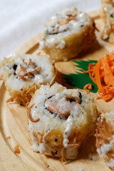 Sushi is traditionally made with medium-grain white rice. It is very often prepared with seafood, such as squid, eel, yellowtail, salmon, tuna or imitation crab meat.