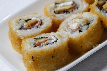 Sushi is traditionally made with medium-grain white rice. It is very often prepared with seafood, such as squid, eel, yellowtail, salmon, tuna or imitation crab meat.