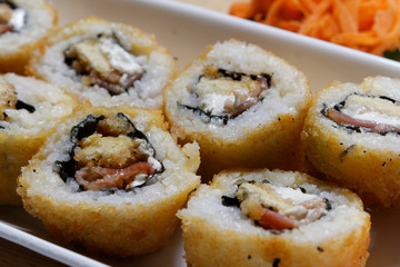 Sushi is traditionally made with medium-grain white rice. It is very often prepared with seafood, such as squid, eel, yellowtail, salmon, tuna or imitation crab meat.