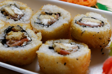 Sushi is traditionally made with medium-grain white rice. It is very often prepared with seafood, such as squid, eel, yellowtail, salmon, tuna or imitation crab meat.