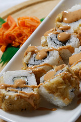 Sushi is traditionally made with medium-grain white rice. It is very often prepared with seafood, such as squid, eel, yellowtail, salmon, tuna or imitation crab meat.
