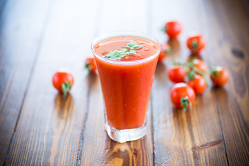 homemade tomato juice in a glass and fresh tomatoes