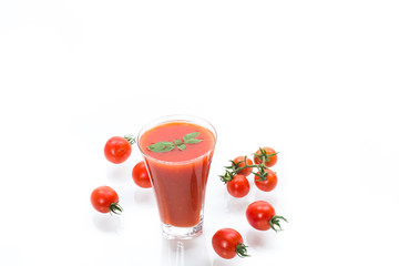 homemade tomato juice in a glass and fresh tomatoes