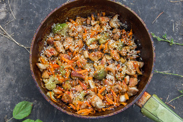 meat broccoli carrots onions garlic with sesame seeds all together in a pan.