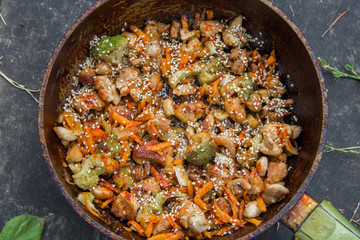 meat broccoli carrots onions garlic with sesame seeds all together in a pan.