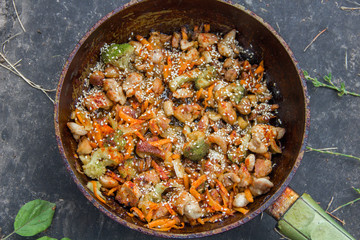 meat broccoli carrots onions garlic with sesame seeds all together in a pan.