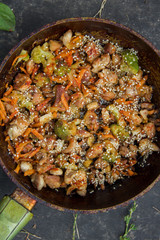 meat broccoli carrots onions garlic with sesame seeds all together in a pan.