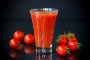 homemade tomato juice in a glass and fresh tomatoes
