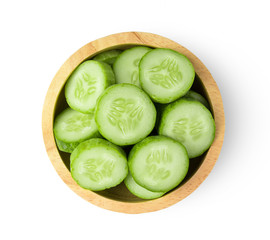.Fresh cucumber slices in wood bowl isolated on white background. top view