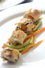 Roasted and sliced chicken fillet stuffed with carrots and pumpkins garnished with vegetables and jamaica sauce.