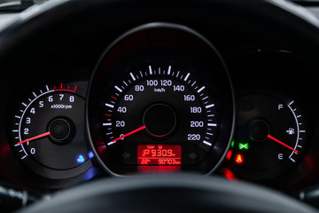 Car dashboard with white  backlight: Odometer, speedometer, tachometer, fuel level, water...