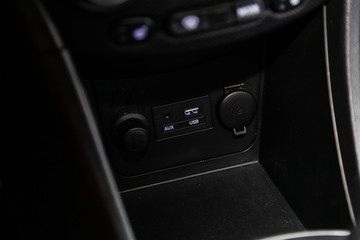Fototapeta premium Close up of a charging in the car, cigarette lighter, aux, usb connectors. modern car interior.