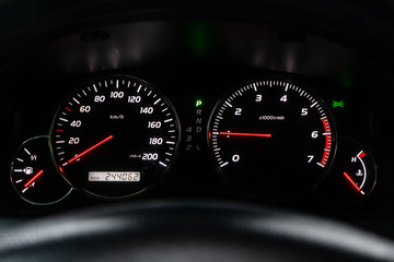Car dashboard with white  backlight: Odometer, speedometer, tachometer, fuel level, water...