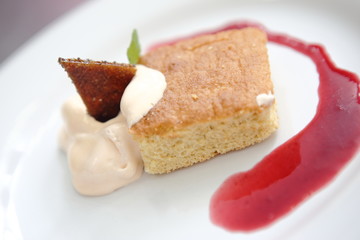 Baked carrot pancake with coconut ice cream and strawberry marmalade.