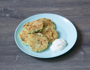 Zucchini pancakes with greens and sour cream