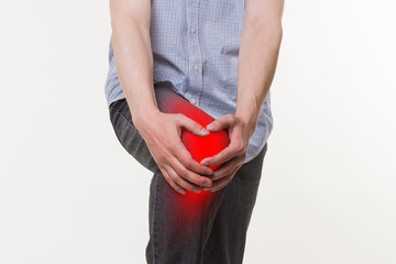 Man with pain in knee, studio shot on white background