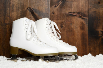  ladies figure skates leaning on wood