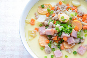 Steamed egg custard cuisine in a white bowl with minced pork, sausage and bacon.  Or Only with egg, water, salt and some sesame oil, you can make this super smooth custard at home.