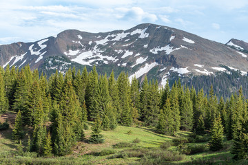Obraz premium Snow dappled San Juan Mountains, trees and meadow at Little Molas Lake in Colorado