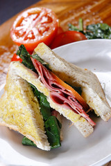 A sandwich club, also called a clubhouse sandwich, is a sandwich of bread, sliced ​​cooked poultry, or fried bacon, lettuce, tomato, and mayonnaise.