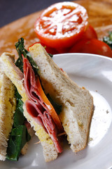 A sandwich club, also called a clubhouse sandwich, is a sandwich of bread, sliced ​​cooked poultry, or fried bacon, lettuce, tomato, and mayonnaise.