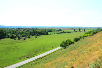 rural landscape with green field and blue sky