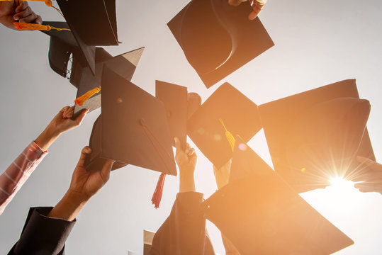 Black hat of the graduates floating in the sky.