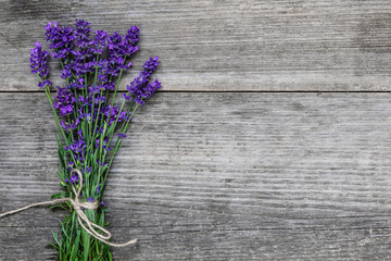 Beautiful lavender flowers bouquet on rustic wooden table with copy space for your text. top view. flat lay