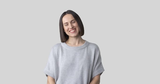 Happy young woman with arms crossed over white background