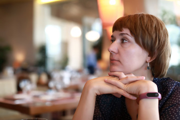 Pensive woman in restaurant