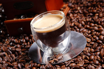 Espresso is coffee of Italian origin, brewed by expressing a small amount of nearly boiling water under pressure through finely ground coffee beans and has crema on top.