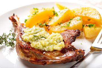 Baked duck steak with garlic sauce and baked potatoes