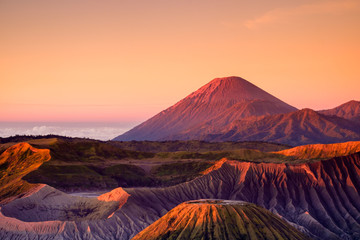 The beautiful sunrise at Mount Bromo volcano, the magnificent view of Mt. Bromo located in Bromo Tengger Semeru National Park, East Java, Indonesia.Image contains noise grain and blurry.
