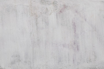 The texture of the unevenly painted white paint of the wall of the house. Abstract background for...
