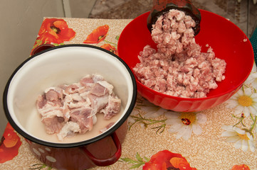 Meat grinder - process of grinding meat. Beef mince in mincing-machine. Cooking food