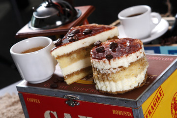 Coffee dessert with vanilla, cocoa chips and marmalade accompanied by two cups of espresso coffee on a traditional wooden box and coffee beans.