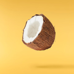 Fresh ripe coconut isolated on yellow background