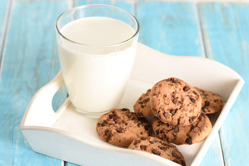 Milk and cookies on the white tray. Biscuit on the turquoise table