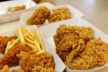 crispy fried chicken and French fries in white cardboard box