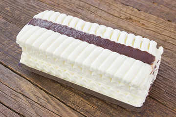 Ice cream vanilla cake torte on wooden table